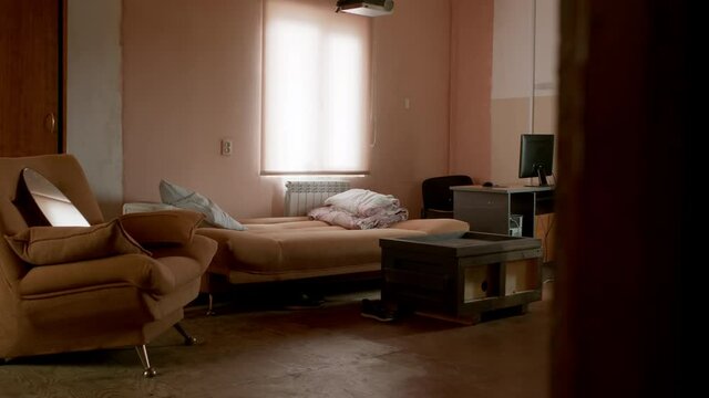 Cheap hotel. Simple room interior. Messy living-room.