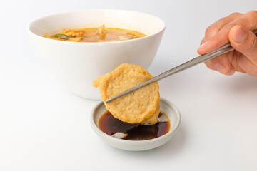Fish cake soup on a white background