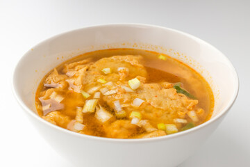 Fish cake soup on a white background