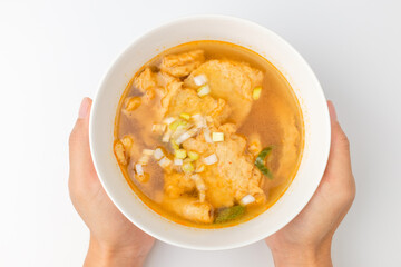 Fish cake soup on a white background