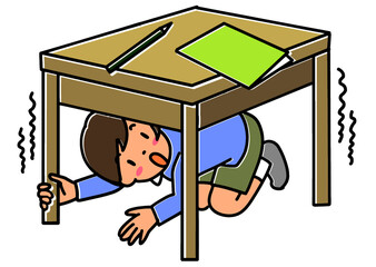 地震のときに机の下にもぐって身を守る子ども