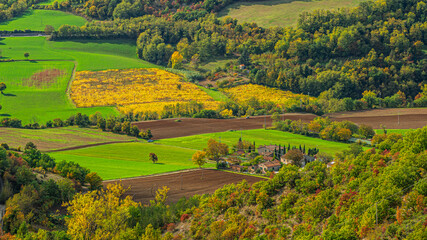 Naklejka premium What we see in this image is farmland in the valley of the Apennine mountain range in central Italy. 