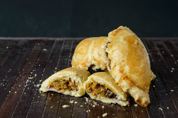 Beef Empanada fill close up. Wooden background.