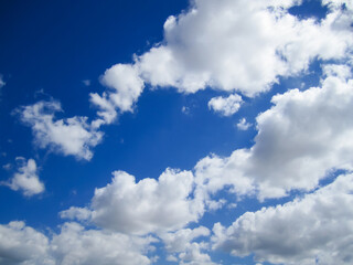 Blue sky and fluffy white clouds- Stock Photo.