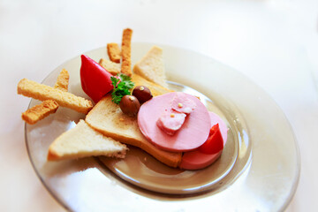 Copy space, merry christmas. Cooking a sandwich in the shape of a bull. Symbol of the new year 2021. Breakfast for children: bread, ham, pepper, tomato