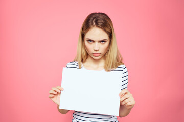 woman holding white sheet in her hands striped t-shirt emotions pink background