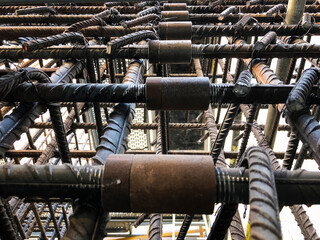 Metal threaded couplings connecting reinforcing rebars. Reinforcement framework