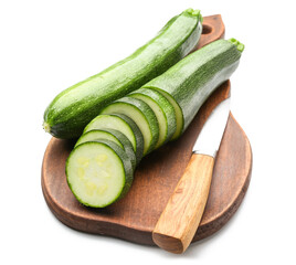 Cutting board with fresh zucchini squashes on white background