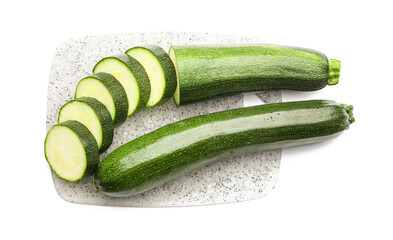 Board with fresh zucchini squashes on white background