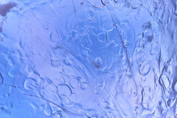macro photography of oil on water in blue tones