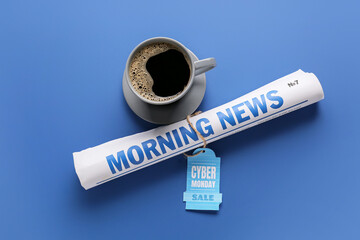 Cup of coffee with newspaper and tag CYBER MONDAY SALE on color background