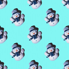 Festive seamless pattern toy snowmen on a light blue background, square layout, top view