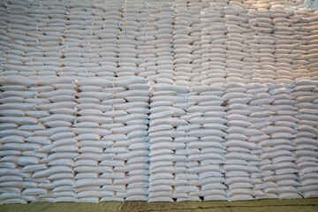 bags of sugar in the warehouse. A wall of sugar sacks in a large warehouse.