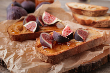 Tasty sandwiches with sweet fig jam on table, closeup
