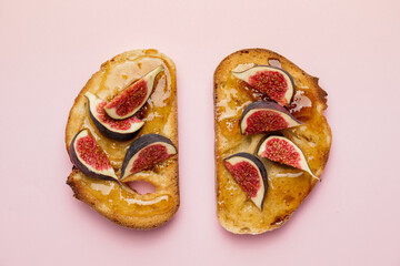 Tasty sandwiches with sweet fig jam on color background