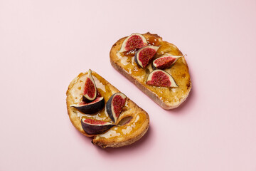Tasty sandwiches with sweet fig jam on color background