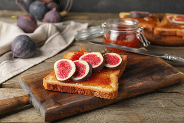 Tasty sandwich with sweet fig jam on table