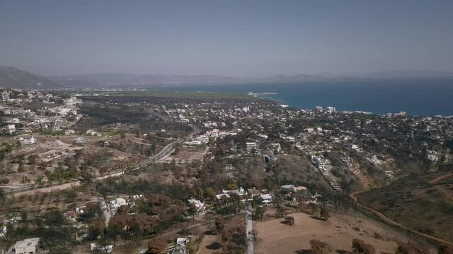Athens in Greece after 2018 Attica wildfires, dry trees and town ruins
