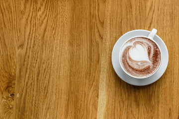 Cup of tasty cappuccino on table in cafe