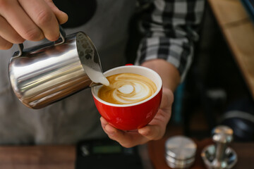 Fototapeta na wymiar Barista making hot coffee in cafe, closeup