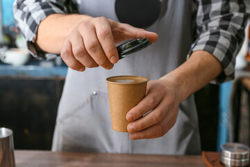 Fototapeta na wymiar Barista with cup of hot coffee in cafe, closeup