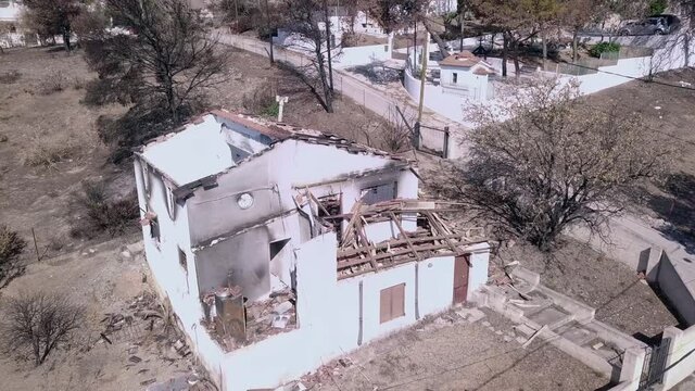 Overhead shot of ruins of a house burned in 2018 Attica wildfires in Athens of Greece, zoom in