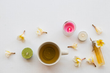 natural herbal oils from flower frangipani smells scents aroma with hot honey lemon tea healthy drinks  on background white