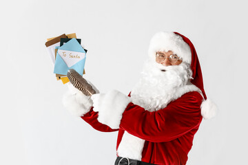 Santa Claus with letters on light background