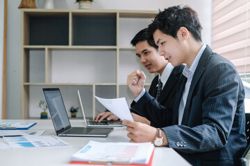 Two young asian businessman working together at office modern.