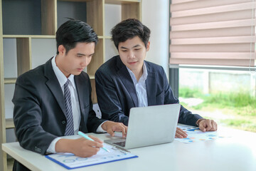 Two young asian businessman working together at office modern.
