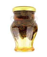 Glass jar of pine cone jam isolated on white