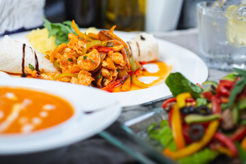 Top view of a restaurant table served with a multi-course set lunch and drink. Complex lunch.