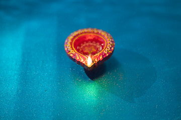 Happy Diwali - Colorful clay diya lamps lit during diwali celebration