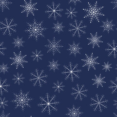 White snowflakes on a dark blue background. Endless textures for your design.
