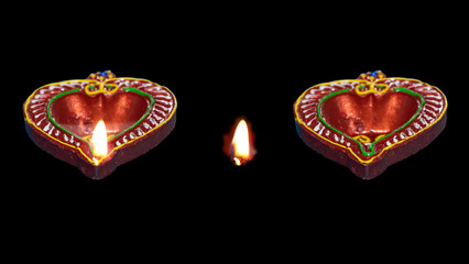 Diya lamp with fire. Traditional Divali festival. Close up