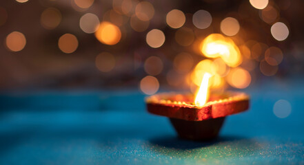 Beautiful clay diya lamps lit during diwali celebration, selective focus