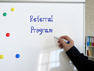 Referral Program inscription on the piece of paper.