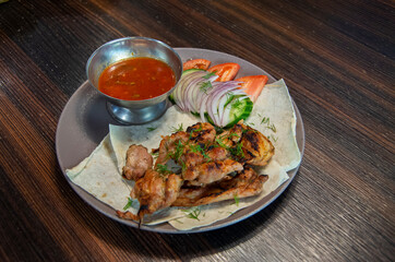 Grilled Chicken breast. Fried chicken fillet and fresh tomato and cucumber salad with tomato sauce. Chicken meat with salad. Healthy food.