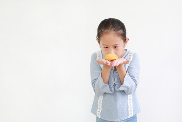 Asian little girl holding Custard Cake isolated on white background.