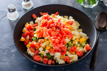 Step by step preparation of the salad with red fish and vegetables, step 5 - adding sliced salted red fish to the salad, selective focus, horizontal