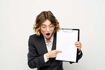 Business woman with a folder of documents on a light background cropped view and shirt suit