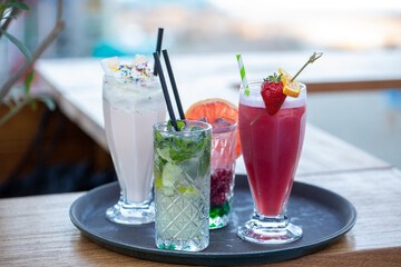 Cocktails and milkshakes on a tray in the cafe