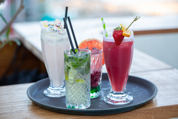 Cocktails and milkshakes on a tray in the cafe