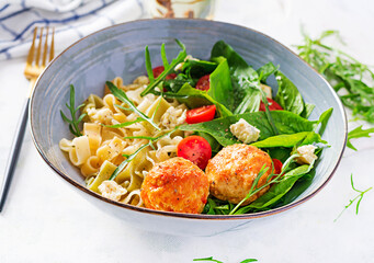 Italian pasta. Pasta  with meatballs,  cheese and fresh salad on light background. Dinner.  Slow food concept