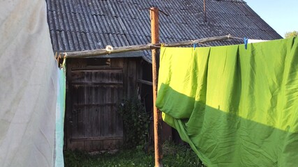 Colorful laundry hanging on the rope outdoors. The process of air drying clothes