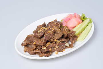 Chinese food, fried duck, garlic, pepper on a white plate