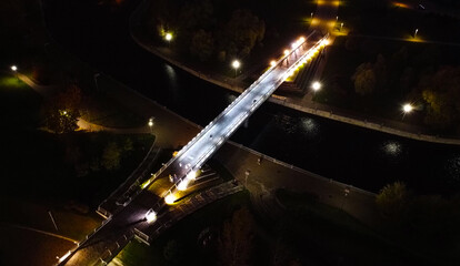 Top view of the night park with a pedestrian bridge and illumination