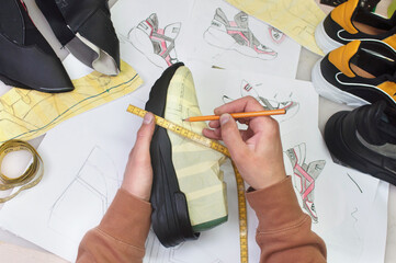 Shoemaker making shoe on the table in workshop