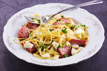 gourmet pasta with mozzarella cheese, herbs and appetizing ham