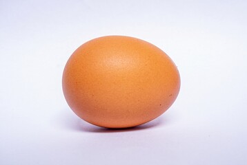 Egg Isolated. Chicken Egg on White Background. Highly Retouched Closeup. Full Depth of Field. Single Brown Egg Absolute Sharpness High Resolution and Quality Image.